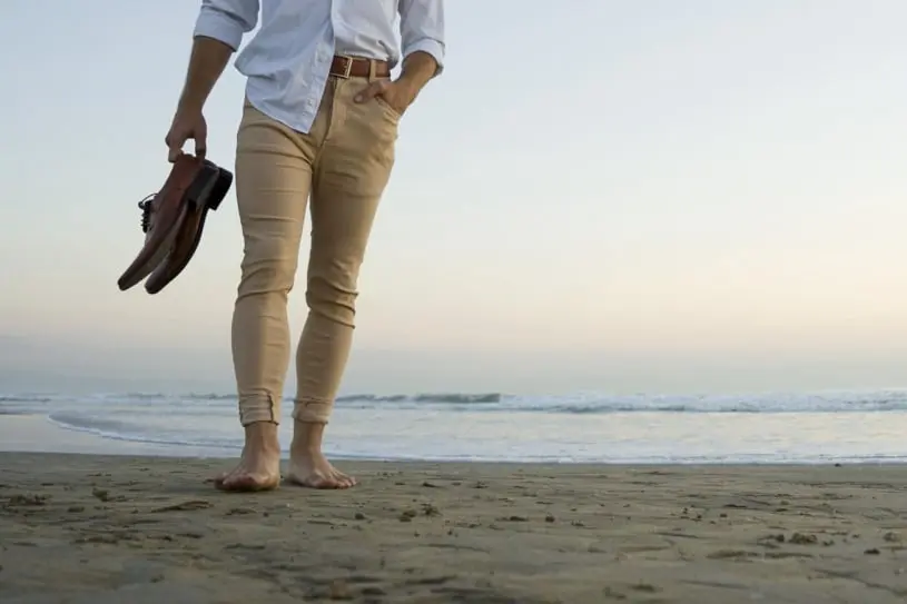 man wearing pant shirt on a beach