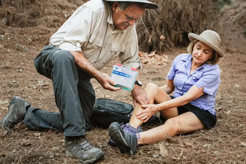man aiding a woman first aid kit