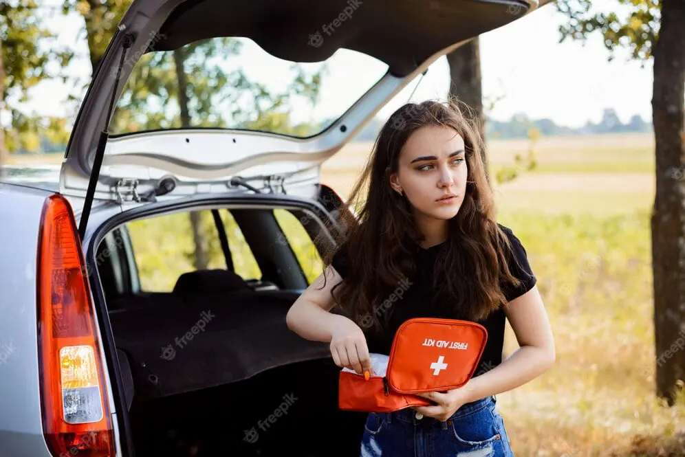 woman holding first aid kit to help at country side